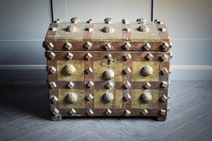 A medium sized Berber dowry chest of West African origin featuring bulbs of metal decorating the outside of the chest complete with key